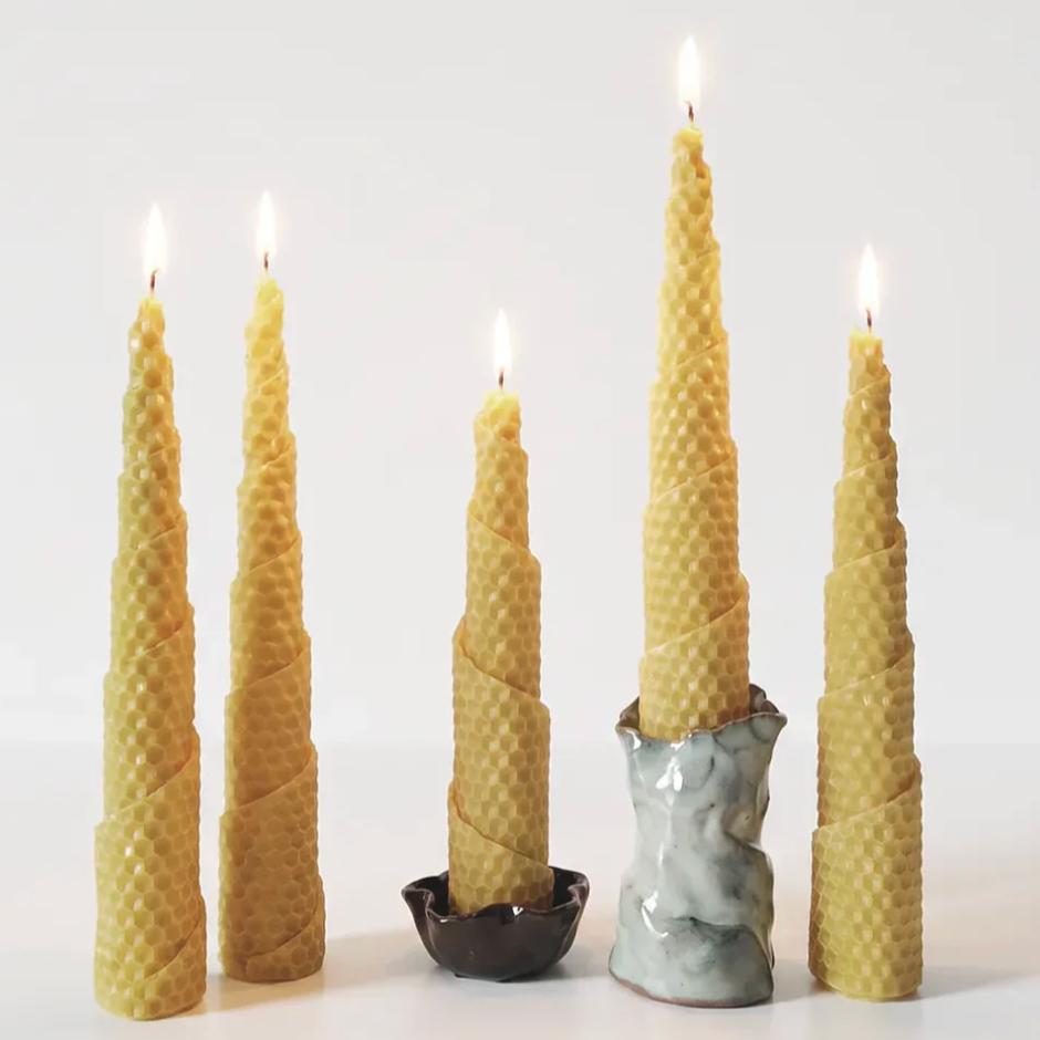 Set of tall, textured bees wax candles on a white background