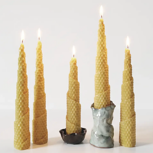 Set of tall, textured bees wax candles on a white background